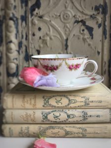 French books, tea cup and flowers