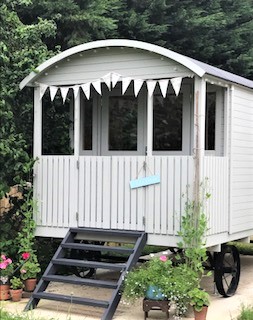 The finished Shepherds Hut in the back garden in summer