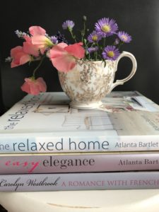 hardback books with jug and flowers