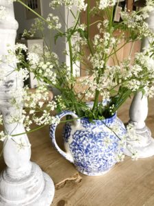 Pre-loved blue jug with cowslip and candlesticks for vintage home decor