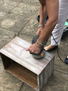 DIY box being sanded with electrical sander