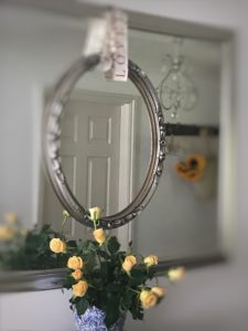 vintage picture frame set in mirror with roses