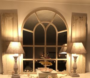 beautiful french barn doors at night with lamps and mirror for vintage home decor