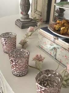 pink candles on sideboard