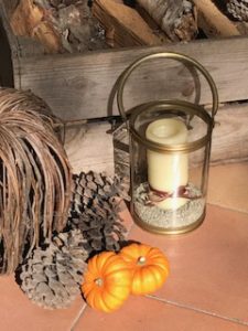 log crate, hurricane lamp and pumpkins