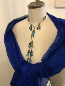 Mannequin in blue scarf and necklace