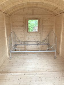 French iron bed inside Shepherds Hut