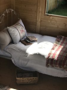 Blogging in Shepherds Hut on French iron bed