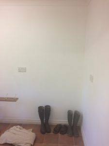 empty room with wellingtons and dust sheet before new year make-over