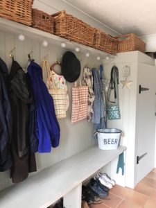 wooden seating area and cupboard in utility room