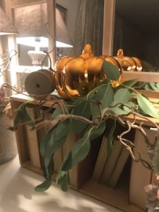 shiny pumpkin old books in vintage box with greenery for autumn display