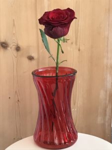 red rose in red vase for room decor