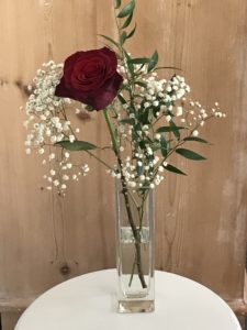 single red rose with greenery and gypsophila for room decor