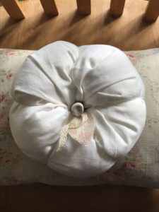 large cotton pumpkin on floral cushion for halloween decoration ideas