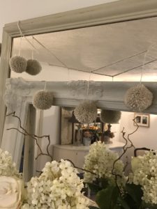 DIY pom-pom garland on mirror