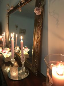 completed mantlepiece with candles mirror and rose garland after faffing