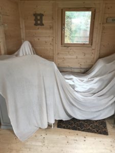 dust sheet covering inside Shepherds Hut during stove installation