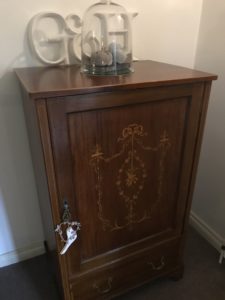 antique music cupboard with glass dome and linen pumpkins in faffing session