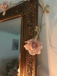 brass mirror detail with rose garland during faffing session