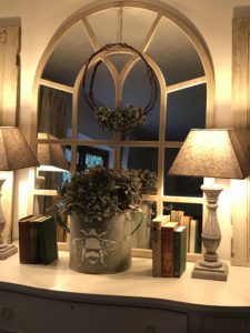 hydrangea wreath on mirror with zinc planter books and lamps in faffing session