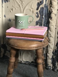 mini stool, books and coffee mug decorating inside the shepherds hut