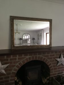 brass mirror on mantlepiece before faffing