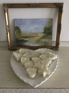 countryside water colour on board with gilt frame and tea light candles