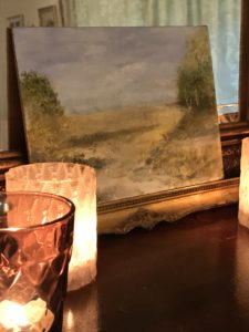 countryside water colour on board with gilt frame and tea light candles