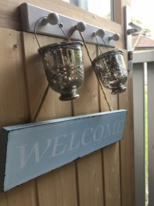 welcome sign and tealights decorating inside of shepherds hut