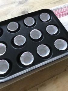 lined muffin tin in preparation for making firestarters