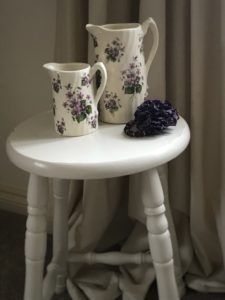 painted bar stool with ceramic jugs and accessories