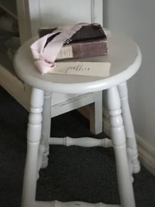 painted bar stool with french book and handwritten tag