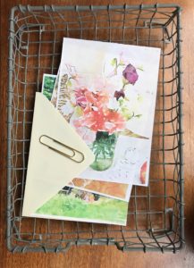 wire tray, gold paper clip and paper and envelope for handwritten letter