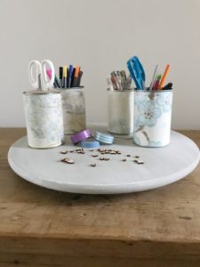 painted lazy susan with wallpapered tin cans scissors washi tape pens pencils and wooden hearts