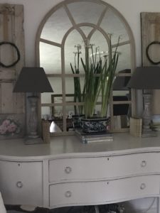 spring bulbs on sideboard with mirror lamps and decor