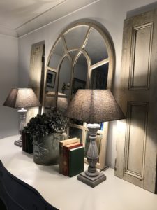 sideboard, mirror, two french lamps, french shutters, hydrangea display and books