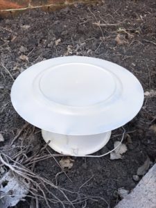 plate charger being sprayed with almond spray paint