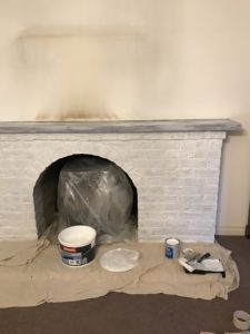 white painted bricks paint and tools used for fireplace makeover