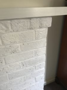 white painted bricks and mantle in fireplace makeovder