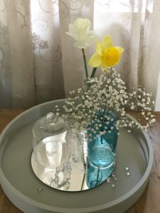 painted tray with gypsophila glass bottles and cloche