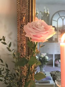 pale pink rose gilt frame reflection and pink candle on painted fireplace