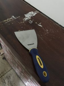 wallpaper scraper removing candle wax before fireplace makeover