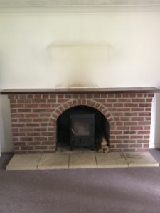 dated brick fireplace stained wall before painted fireplace makeover