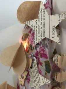 selection of pretty card and paper garlands with fairy lights