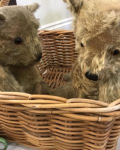 vintage teddy bears in wicker basket at spring fair