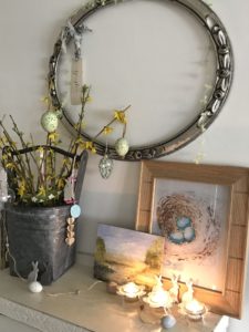 tin bucket with decorated yellow twigs as easter tree in spring decor