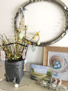 tin bucket with decorated yellow twigs as easter tree in spring decor