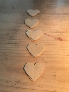 brown paper hearts stacked and in a row ready to stich for paper garland