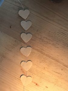 tiny paper hearts stitched to make paper garland