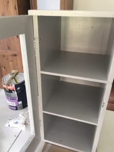 view of inside painted grey wooden pot cupboard